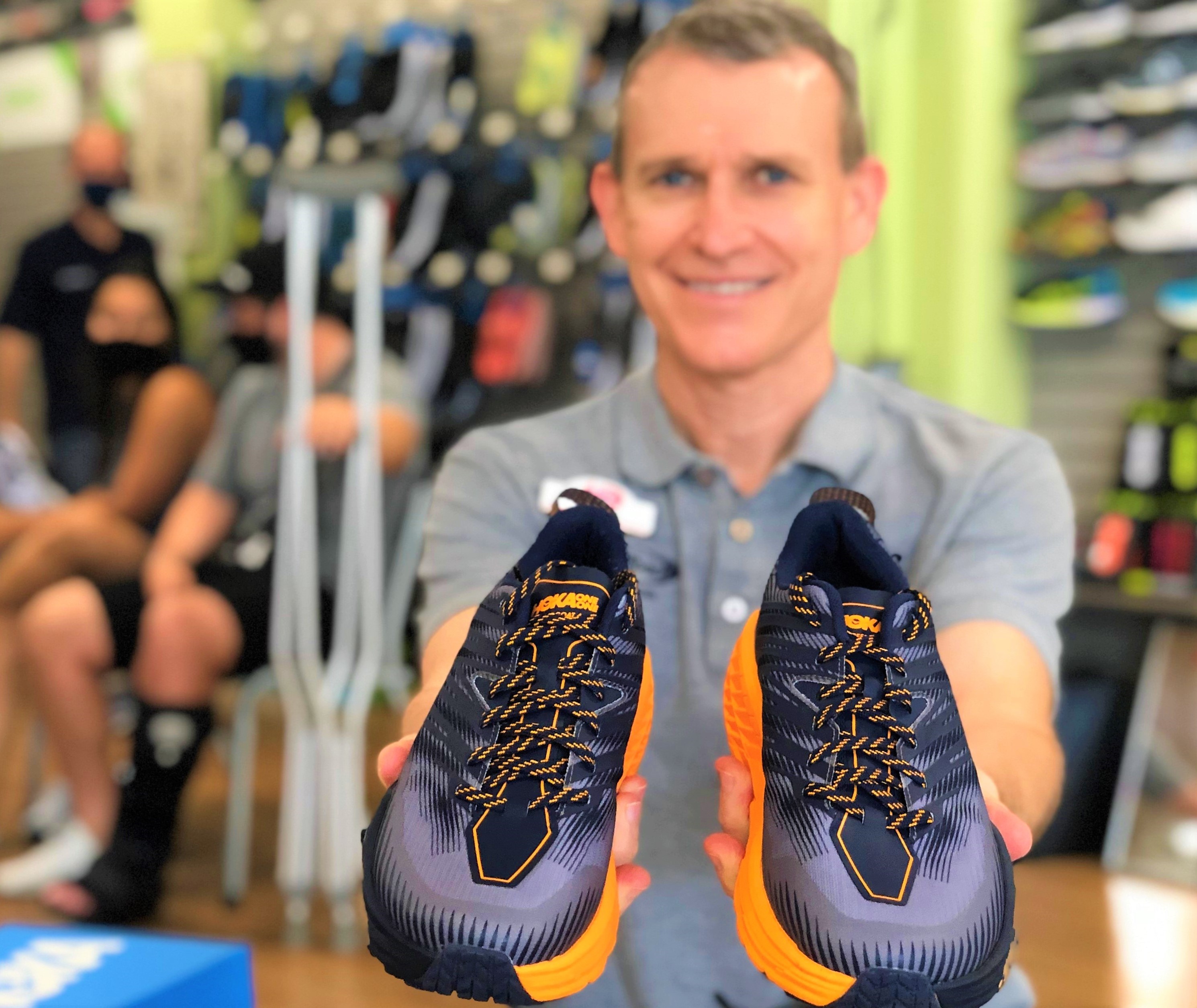 store employee with Hoka One One